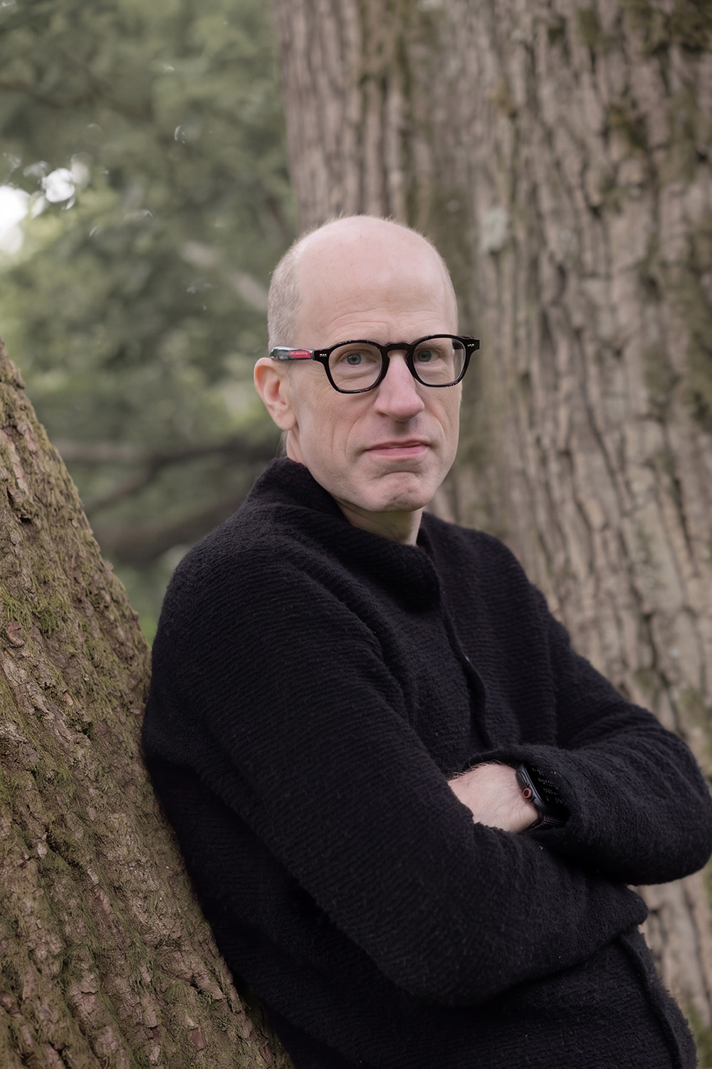 Outdoors portrait of Nick Bostrom leaning against a tree
